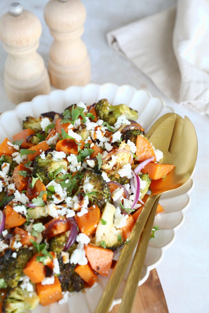 Oven-roasted broccoli and sweet potatoes with feta is a simple veggie side dish loaded with flavors. Ready in only 30 minutes in the oven!