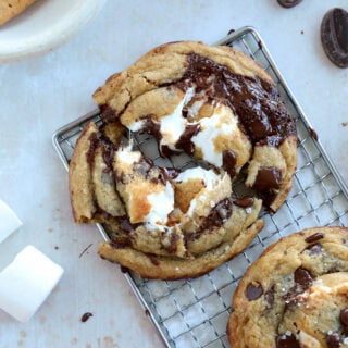 These utterly decadent s’mores chocolate chip cookies are inspired by those nostalgic campfire s’mores and made into a bakery-style dessert.