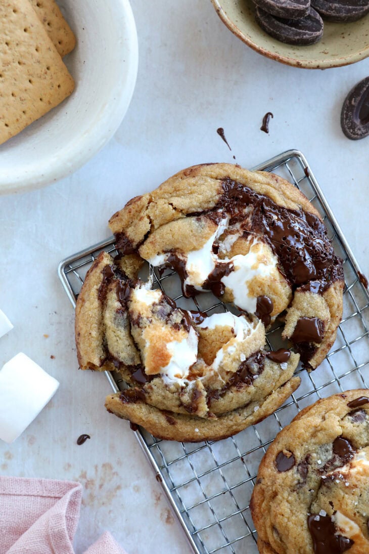 These utterly decadent s’mores chocolate chip cookies are inspired by those nostalgic campfire s’mores and made into a bakery-style dessert.