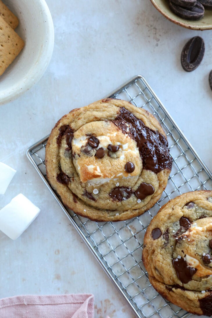 These utterly decadent s’mores chocolate chip cookies are inspired by those nostalgic campfire s’mores and made into a bakery-style dessert.