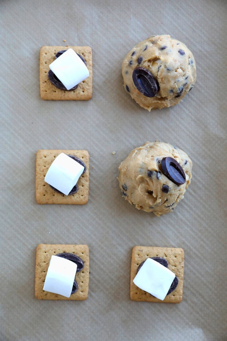 These utterly decadent s’mores chocolate chip cookies are inspired by those nostalgic campfire s’mores and made into a bakery-style dessert.